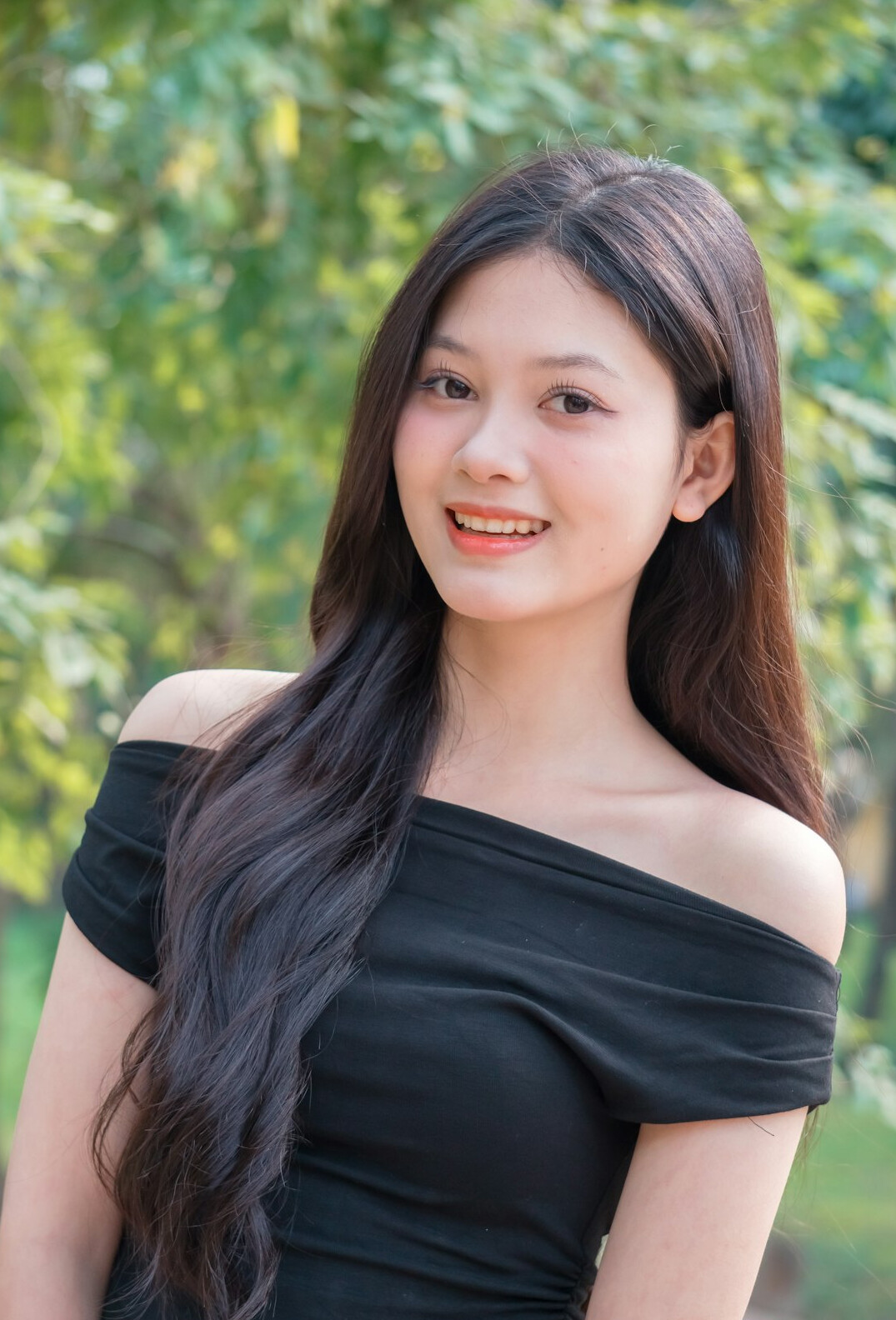 Portrait of a woman with long dark hair smiling